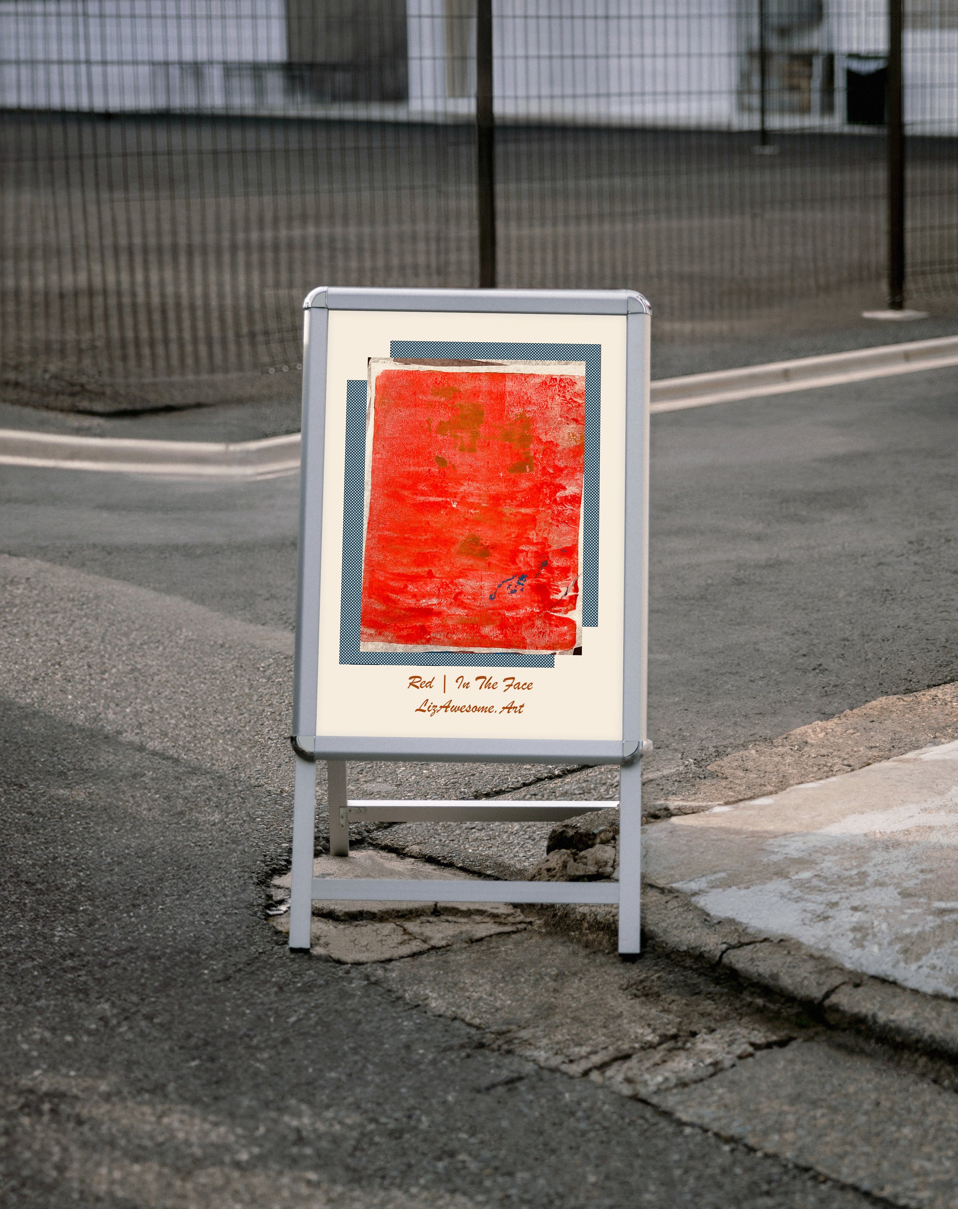 a street sign on a street corner with a red paining titled "RED | In the Face Liz Awesome Art"